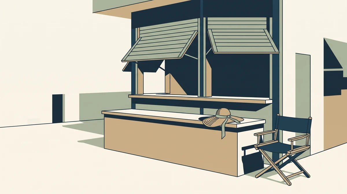 A quiet market stall with its shutters half raised, a straw hat on the empty counter and a folded chair beside it.