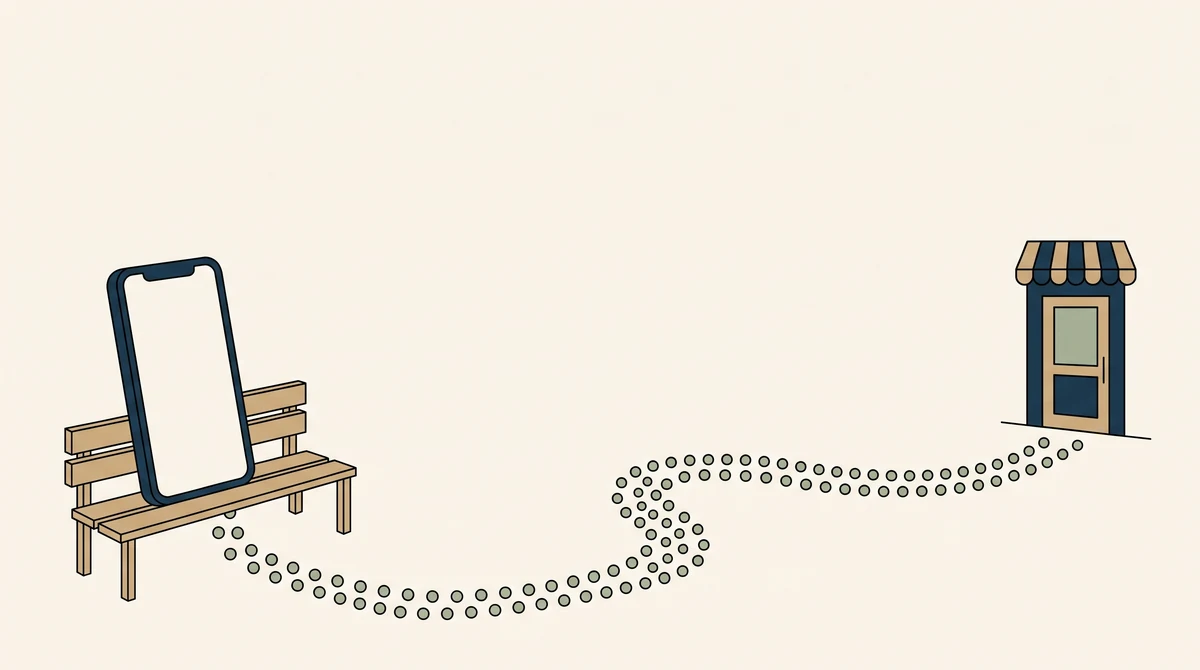 A phone standing upright on a bench with a dotted path curving away from it to a small shop doorway.
